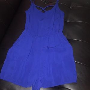 Blue romper with straps crossed in the back